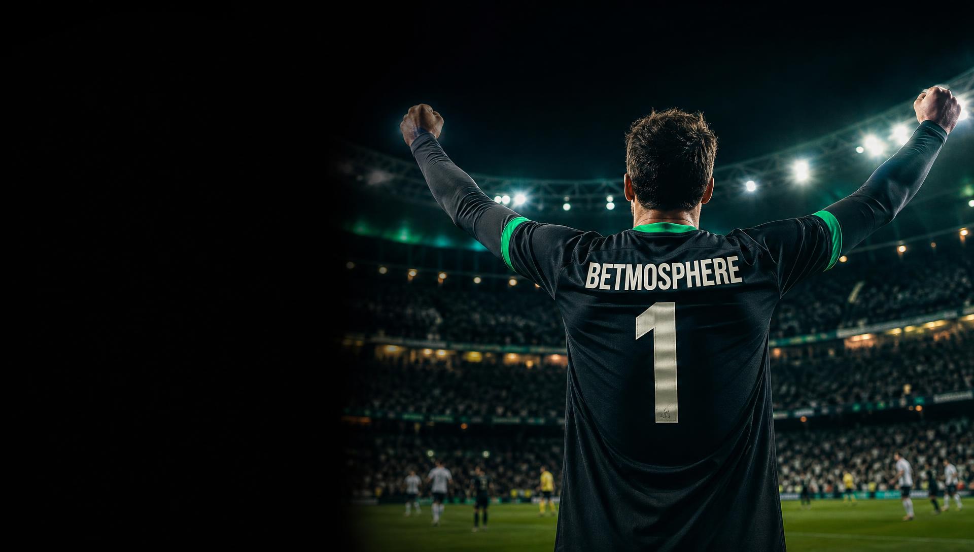 Footballer celebrating in a floodlit stadium wearing a Betmosphere number 1 jersey